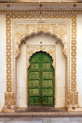 Fototapeta na wymiar Jodhpur, Rajasthan, India – December 27, 2014 : Details of an old style well decorated door in the Mehrangarh Fort - Jodhpur