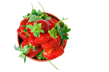 Group of fresh strawberries in the clay bowl isolated on a white background