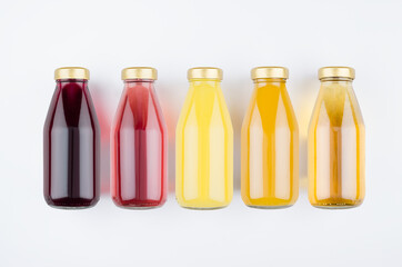 Collection of fresh various fruits juices - muddy and transparent in glass bottles  on white background, mock up for design, advertising, branding product.