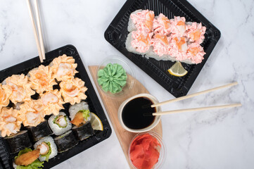 Sushi rolls set in take away boxes
