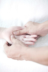 Fototapeta premium Massage therapist massaging woman's palm
