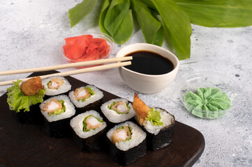 Sushi roll set with fried shrimp and salad