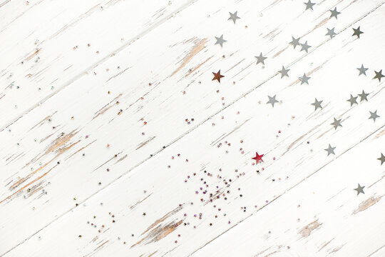 shiny christmas stars on white wooden background, layout with copy space
