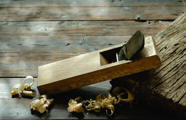 Japanese wood planer Placed on an old dark wood table  left side copy space - obrazy, fototapety, plakaty