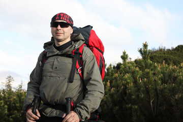 Active healthy man hiking in beautiful forest