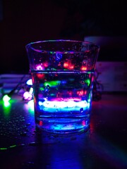 A glass of vodka with a beautiful and colorful bokeh background
