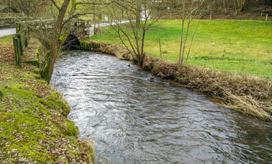 Fototapeta premium Creek with natural stone bridge in the Odenwald, Germany