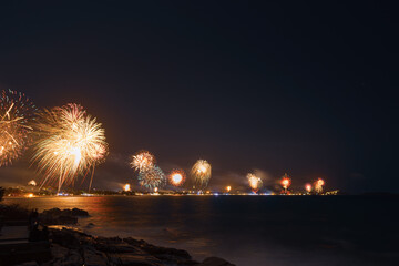 Night fireworks over the coast and the sea