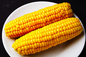 boiled corn on a white plate