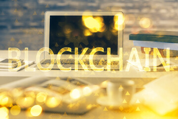 Multi exposure of blockchain theme hologram and table with computer background. Concept of bitcoin...
