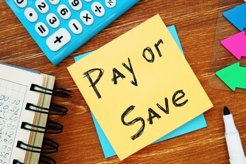 Business concept about Pay Or Save with sign on the piece of paper.