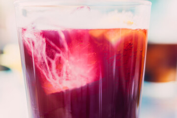 appetizing drink in glass with red soda and ice