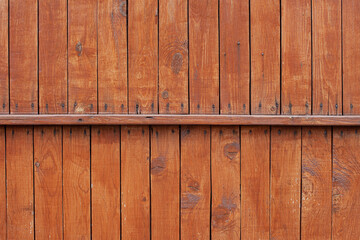 Vertical old wooden burned orange planks with rusty nails