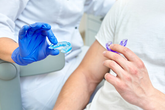 Dentist Doctor Holds Dental Tray And Shows The Patient. Mouth Guard