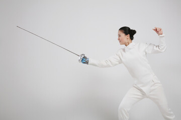 Woman in fencing suit with fencing foil