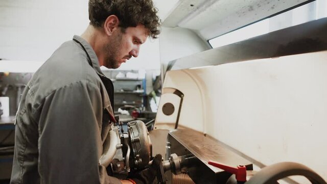 Auto mechanic repairing a car in a workshop.car repair concept