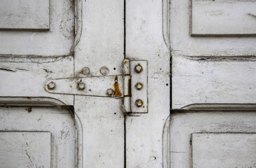 Old rusty hinge on a wooden window