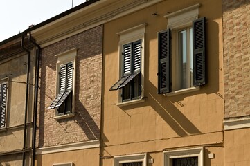 Old window shutters opened of a vintage brick house (Pesaro, Italy, Europe)