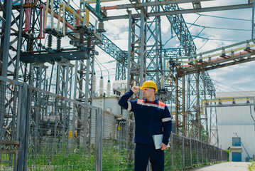 The energy engineer inspects the equipment of the substation. Power engineering. Industry.