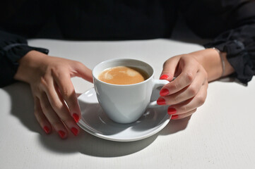 Young Woman with Coffee and Red Nail Polish