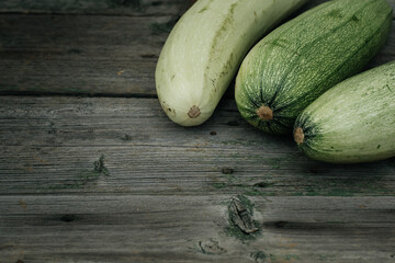 Fresh organic zucchini on the wooden table.