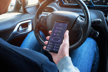 Car information on the mobile app on smart phone in the hands of the driver