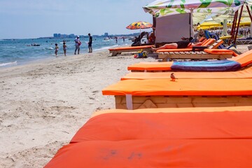 Beautiful shot of an orange sheet Sun Bed in Rimini beach Italy