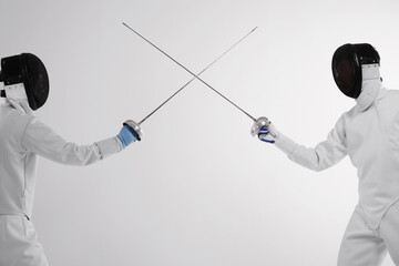 Two men in fencing suits in a duel