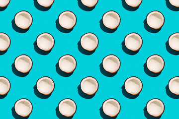 Coconut pattern on pastel blue background. Sunny summer concept. Flat lay.