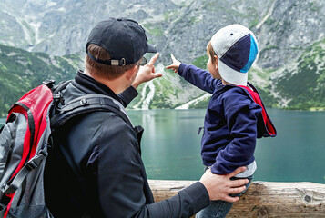 Father and his son near the Eye of the Sea lake (Morskie Oko) in Tatra mountains. Poland.