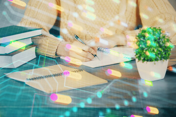 Double exposure of writing hands on background with data solution hologram on front. Technology concept. Close up