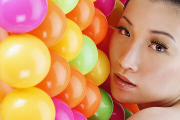 Fototapeta na wymiar Woman posing with multi-coloured balls