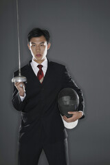 Businessman with a fencing foil and mask