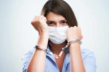 Attractive woman wearing protective mask isolated over white background