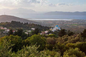 Fototapeta na wymiar Church in Kos Island at sunset to the surrounding island landscape