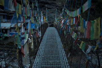 Chame suspension bridge colorful buddhist prayer flags, Annapurna circuit, Nepal