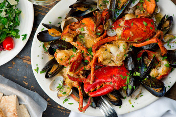 Lobster, mussels, clams and shrimp. Classic Italian restaurant entree favorite. Seafood stew baked in wood fire over and severed with olive oil, lemons and garnished with Italian parsley.