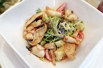 Salad with squid on plate
