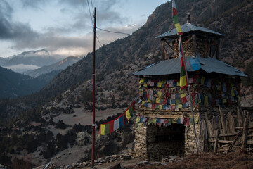 Buddhist prayer flags stone monument, Upper Pisang, Annapurna circuit, Nepal