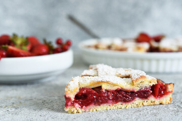 Cake with cherries and icing sugar on a concrete background. Sliced Cherry Pie.