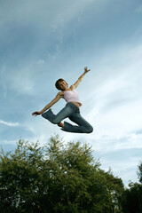 Teenage girl jumping with joy