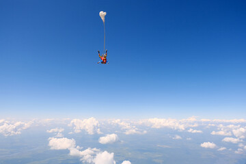 Skydiving. Tandem jump.  Happy girl and her instructor are flying in the sky.