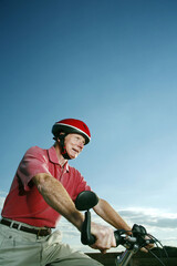 Fototapeta na wymiar Senior man with helmet riding on bicycle