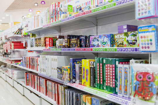Moscow, Russia, 06/18/2020: A large selection of board games for children on the shelves in a bookstore. Educational toys and training.