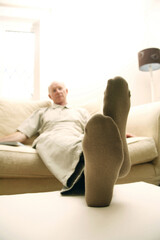 Obraz premium Senior man resting on couch