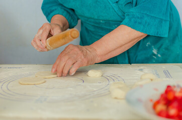 process of sculpting home-made pierogi. Grandma prepares a national Ukrainian dish - vareniki