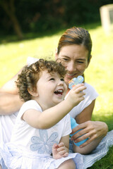 Mother and daughter having fun in the park