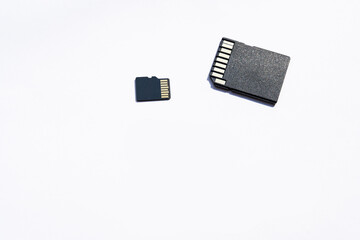 a couple of black sd and micro sd memory cards on the white background. selective focus