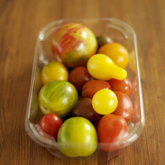 Fresh tomatoes in a transparent container
