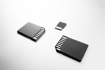 Close-up of three flash cards, technology products, selective focus. memory cards on a white table 
